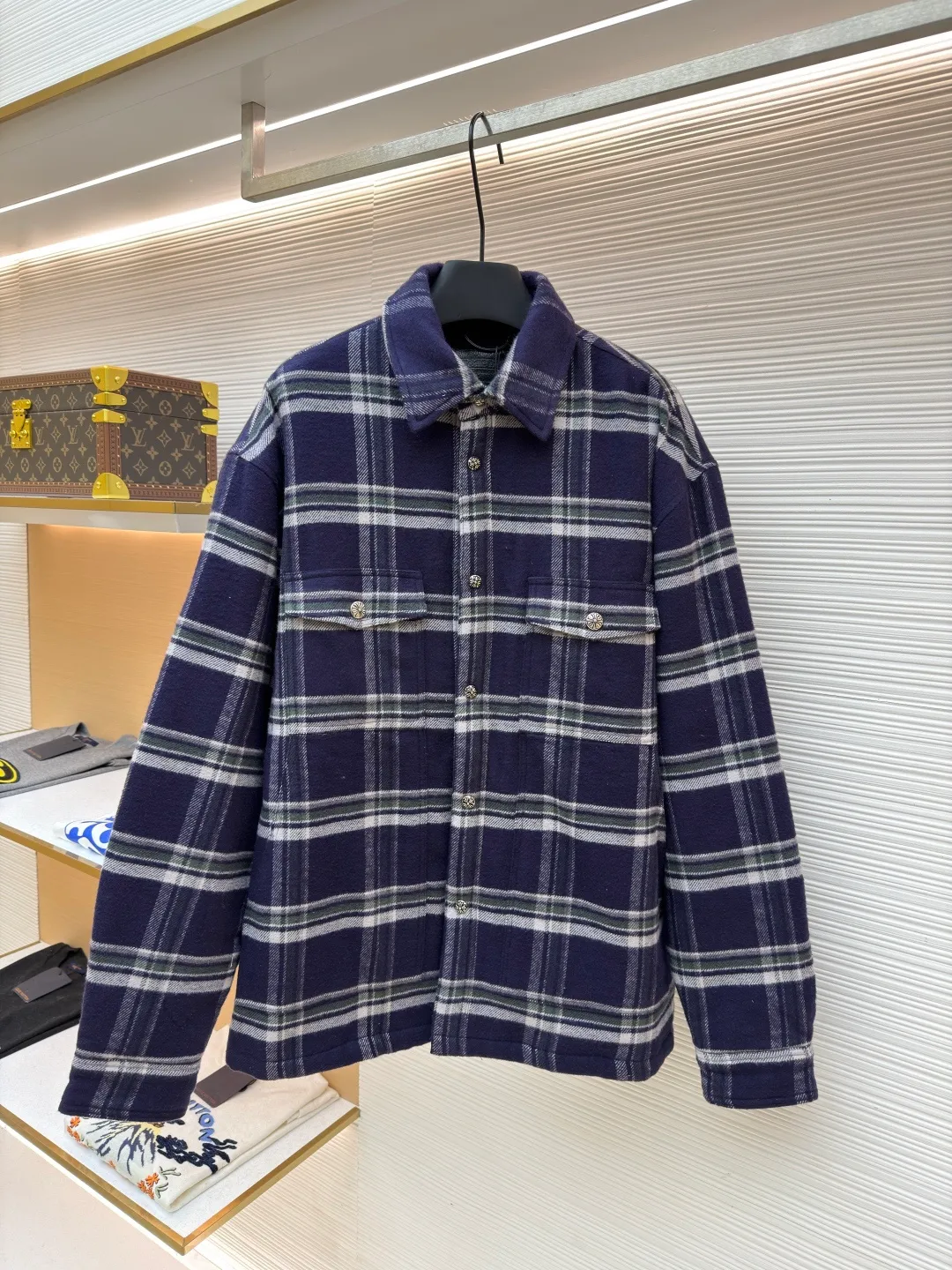 Chrome Hearts Contrast Checkered Lapel Shirt Jacket ●Item No.: 1682307-C05 ●Fabric: Cotton Fabric ●Technology: Made on Positioning Cutting Machine ●Color: Blue and White Plaid ●Version: Fitted ●Weight: Approximately 1030g ●Size: S-M-L-XL ●Description: This Louis Vuitton plaid shirt-style jacket is made of high-count wool blended brushed fabric imported from Italy. It is woven into a classic blue, white and green plaid pattern through yarn-dyed jacquard technology. The yarn is first dyed and then woven to ensure that the plaid color is clear and not easy to fade. The fabric has been pre-shrunk, and the shrinkage rate is controlled within 1%. The body pieces are cut using laser positioning, and the check pattern alignment error does not exceed 0.3cm. The double patch pockets on the front are sewn with welted three-dimensional sewing technology, and the edges of the pockets are padded for a crisper shape. The placket is equipped with custom metal engraved snap buttons, which accurately echo the plaid pattern of the body; the shoulders are made of seamless epaulette splicing technology, and the wiring is smooth and seamless. The double-needle locking technology on the cuffs and hem enhances durability. The overall stitch length is maintained at 7 needles per centimeter, and the wiring is even and smooth. The lining is made of breathable cotton and linen blended materials, taking into account texture and wearing comfort, fully demonstrating the brand's exquisite clothing technology. The overall wiring is straight and delicate, the fabric is comfortable and soft, and the color is consistent without color difference. It can be matched with the same style to create a fashionable look and control various occasions. Customized accessories, complete with three standards, same style for men and women!